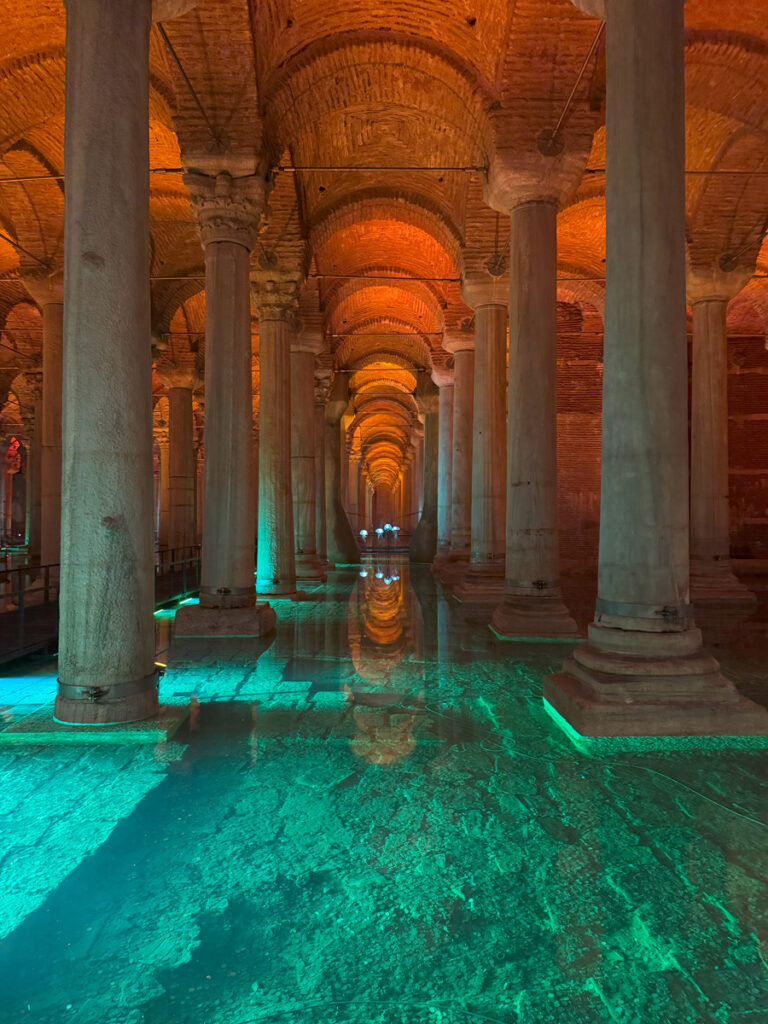 Basilica Cistern illuminated interior with glowing water reflections in Istanbul