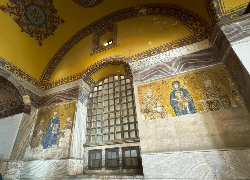 The current condition of two Byzantine mosaics in Hagia Sophia’s upper south gallery: the 11th-century Empress Zoe mosaic (left) and the 12th-century Comnenus donor mosaic (right), both depicting the Virgin Mary with the Christ Child and imperial figures.