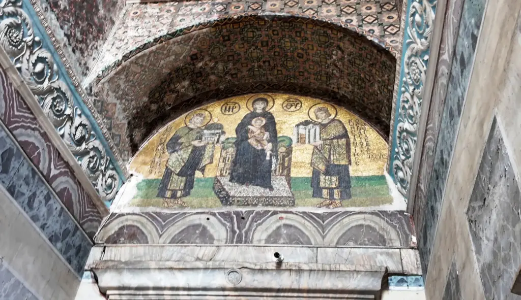 The Virgin and Child mosaic with donor emperors in the southwest vestibule of Hagia Sophia, viewed from below. This 10th–11th century Byzantine mosaic depicts the Virgin Mary holding the Christ Child, flanked by Emperor Constantine I and Emperor Justinian I presenting the city and the church.
