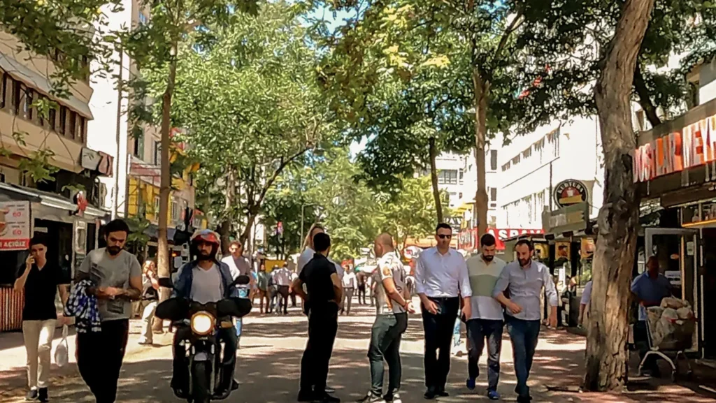 People walking through a shaded street in Kızılay, Ankara