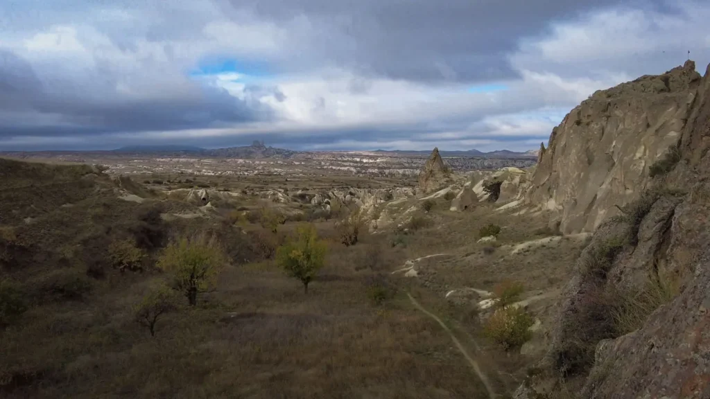 A quiet valley path in Cappadocia under a cloudy morning sky
