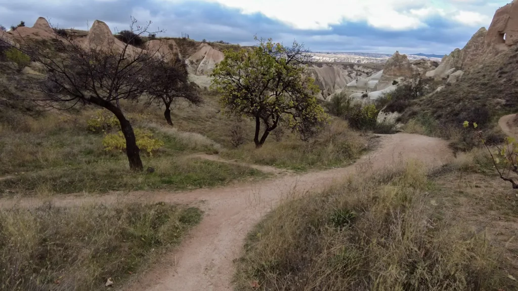 A quiet valley path in Cappadocia under a cloudy morning sky
