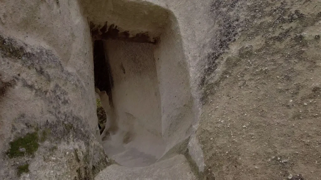 Narrow rock passage carved into stone in Cappadocia