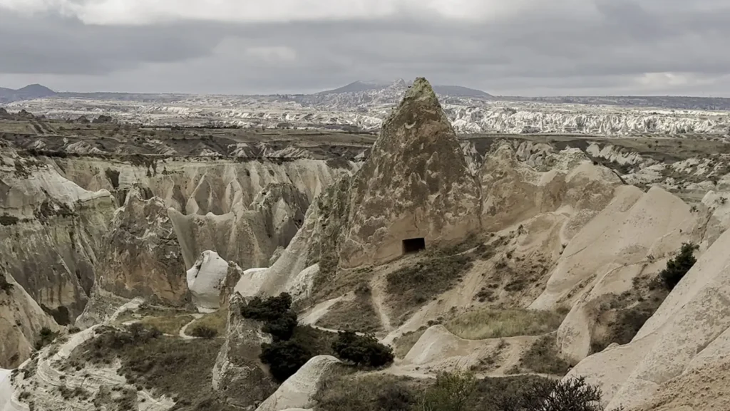 A quiet rocky valley in Cappadocia beneath a cloudy sky