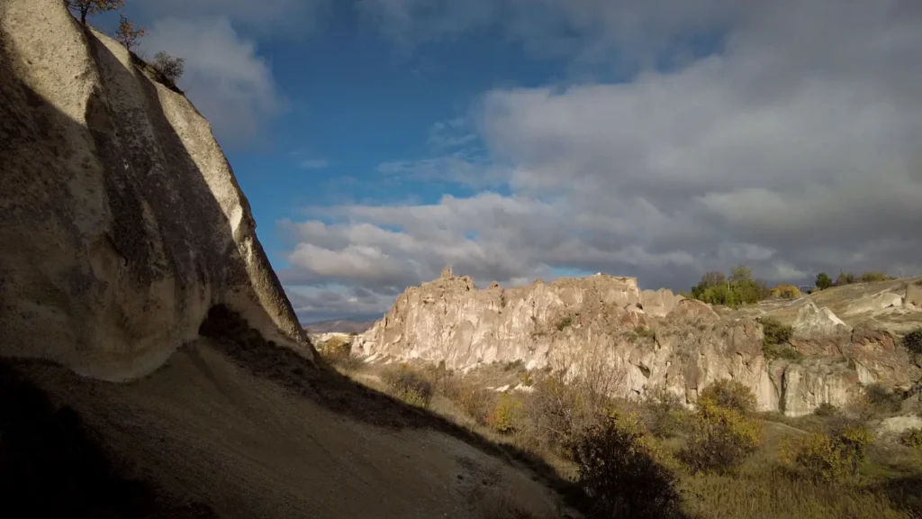 Rock shadows along a quiet path in Cappadocia at dusk