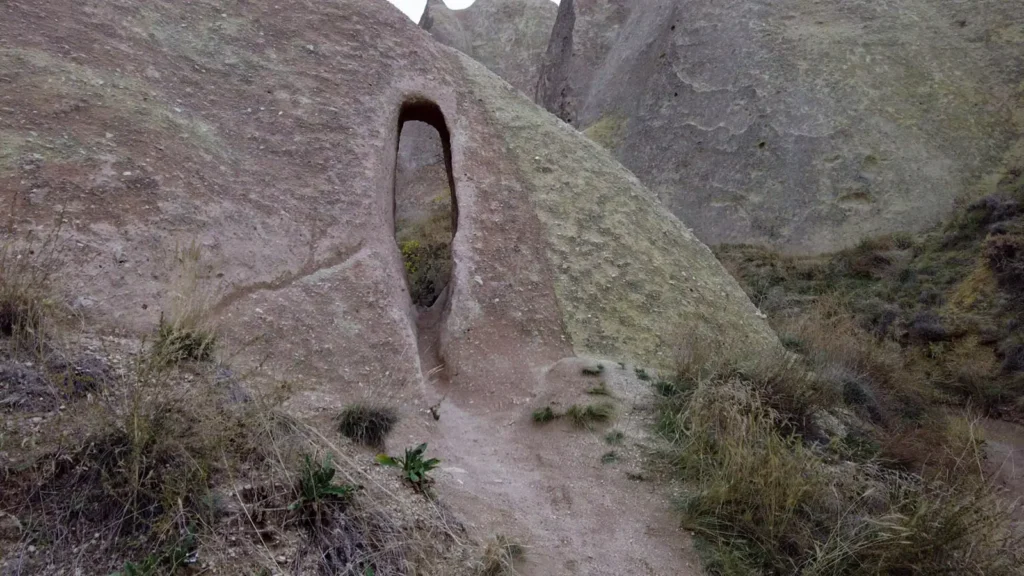 A narrow stone opening in the rock formations of Cappadocia
