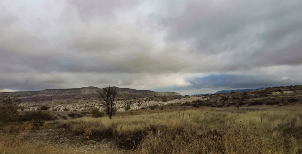 A quiet valley beneath storm clouds in Cappadocia