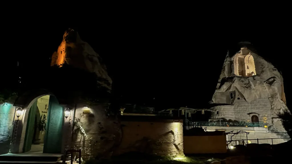 Illuminated cave hotel in Göreme at night