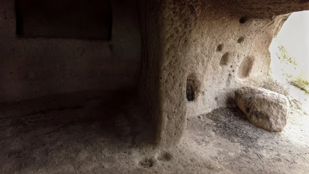 Shadowed cave interior carved into rock in Göreme, Cappadocia