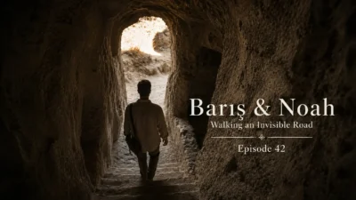 Barış walks toward the light at the exit of Derinkuyu Underground City in Cappadocia.