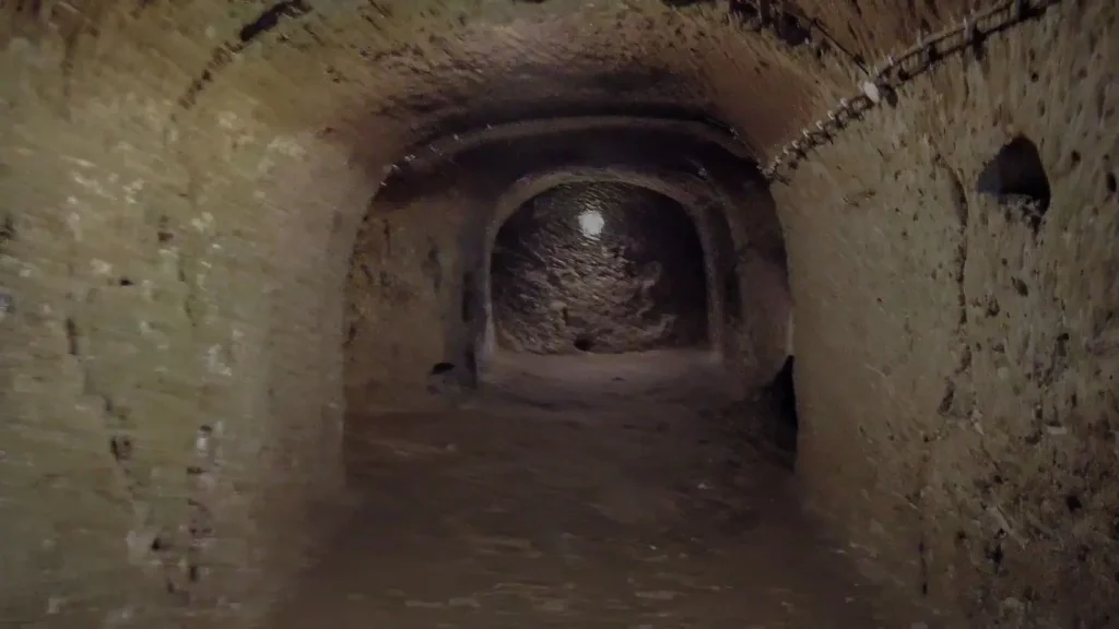 An original photograph of a quiet stone corridor inside Derinkuyu Underground City in Cappadocia.