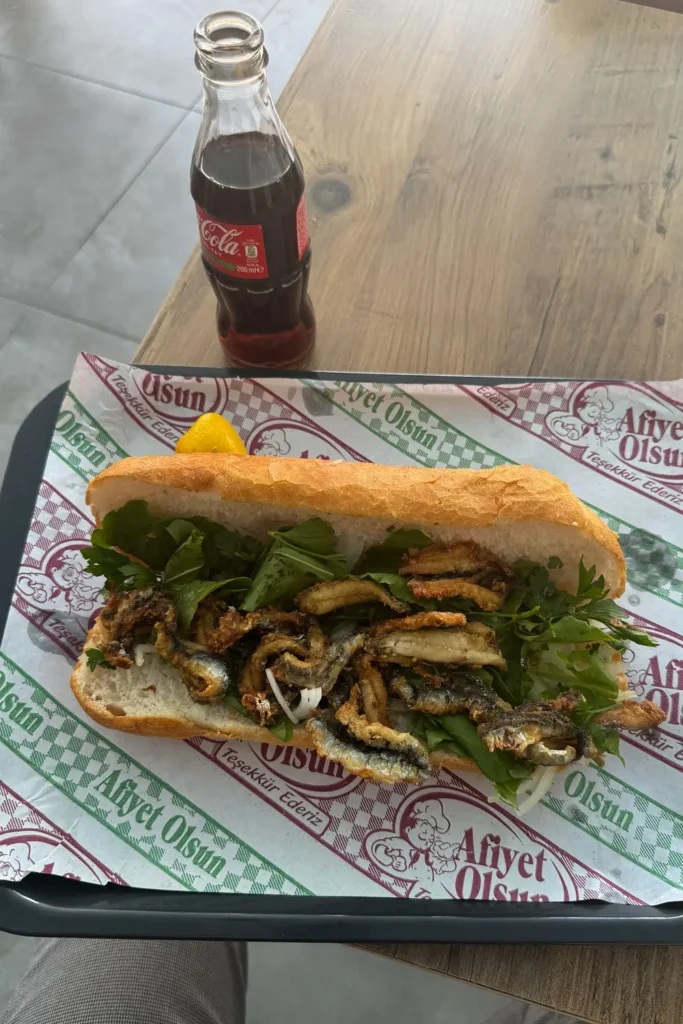 Hamsi ekmek with fried anchovies and greens eaten near Ulus Hali in Ankara