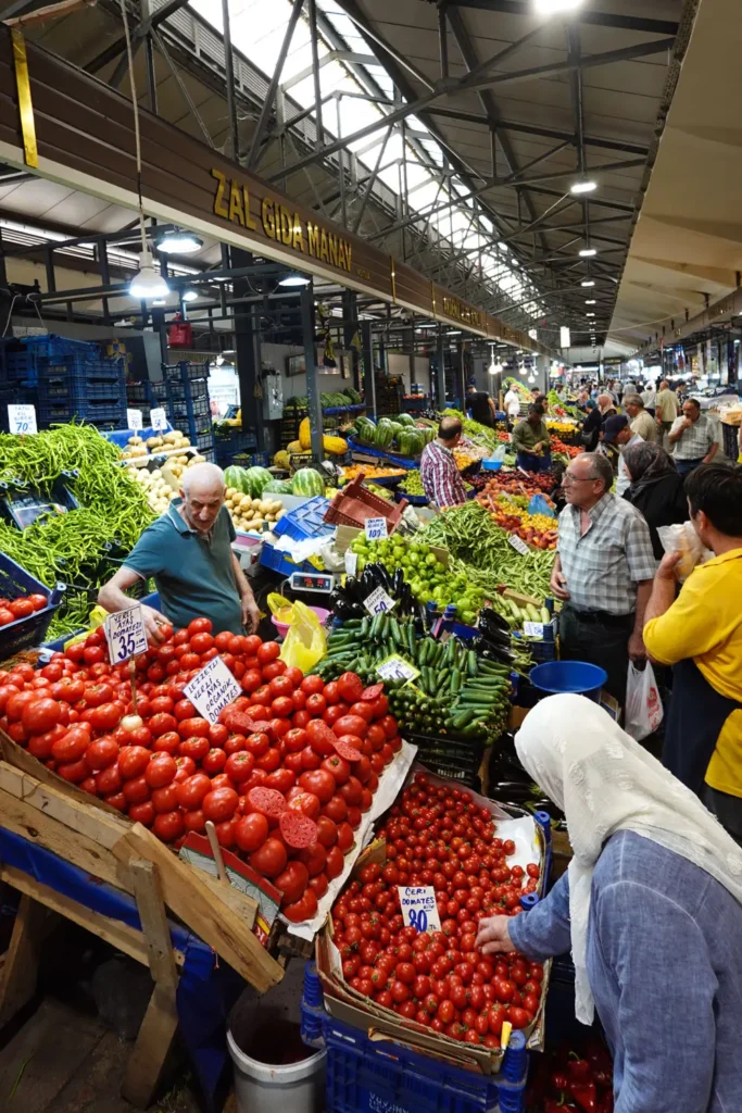 Tomatoes and fresh vegetables displayed at a produce stall inside Ulus Hali
