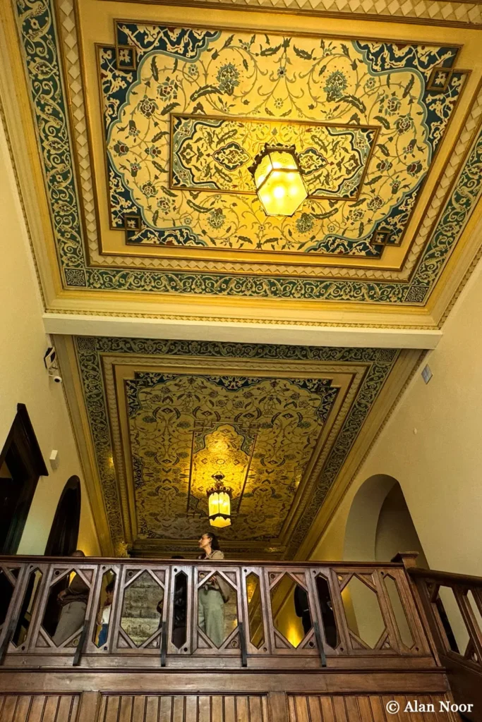 Decorative painted ceiling, hanging lanterns and wooden gallery railing inside Ankara Republic Museum in Ulus, Ankara.