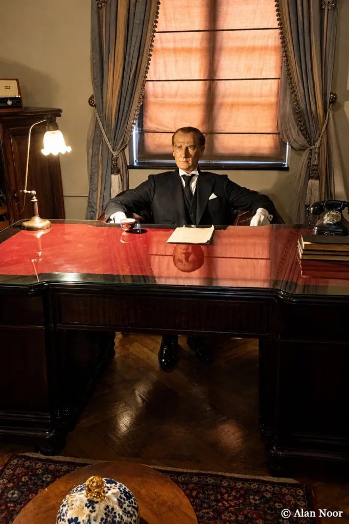 Seated wax figure behind a wooden desk in a reconstructed historic office at Ankara Republic Museum.